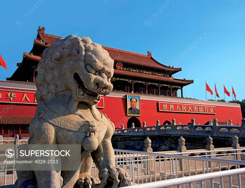 China, Beijing, The Forbidden City, Gate of Heavenly Peace, formidable stone lion guarding the entrance at the North Gate at sunset.