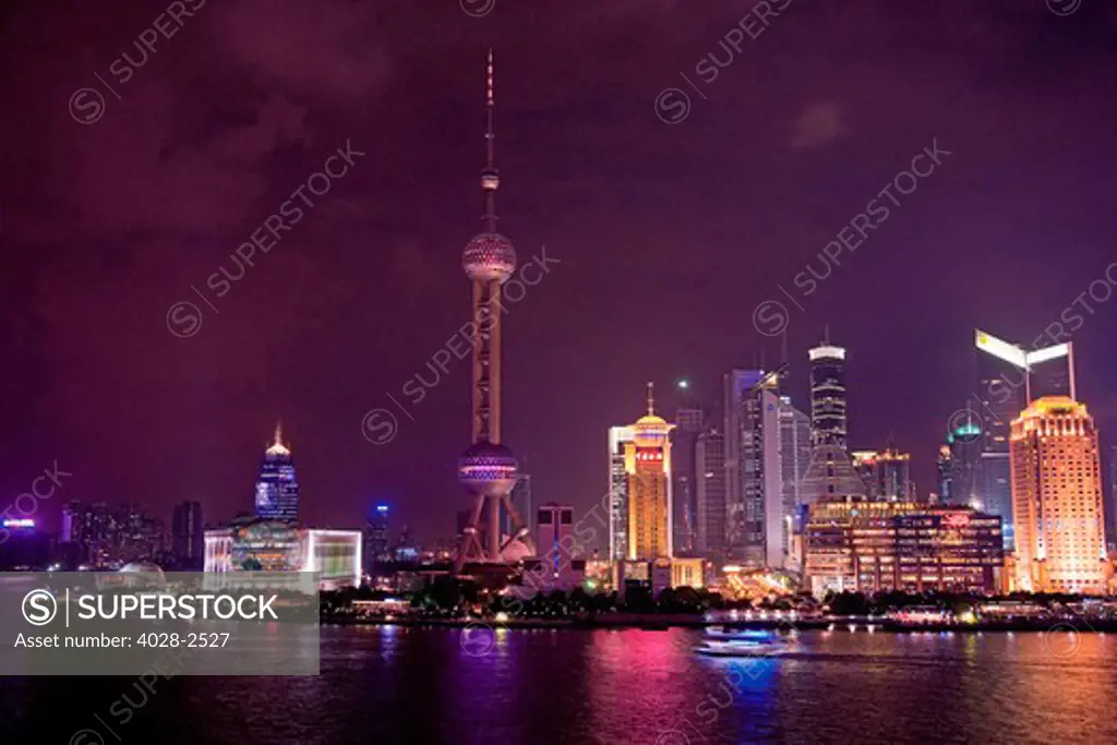 China, Shanghai, Lujiazui, Pudong Park, Oriental Pearl Tower, the world's third tallest TV and radio tower. Huangpu River is in the foreground.
