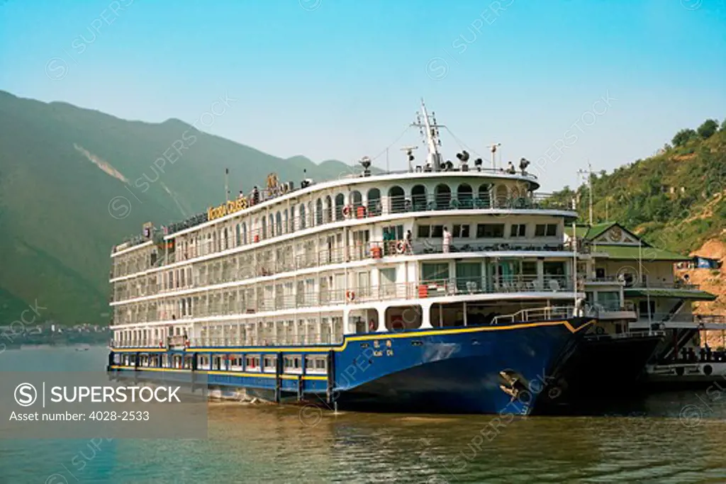 China, Yangtze River, A Victoria Cruise's River boat is docked along the river.