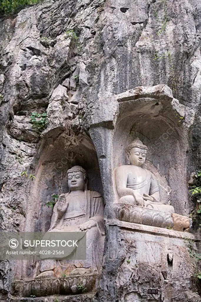 China, Hangzhou, Lingyin Buddhist Temple, a statue of Buddha carved into the mountain.