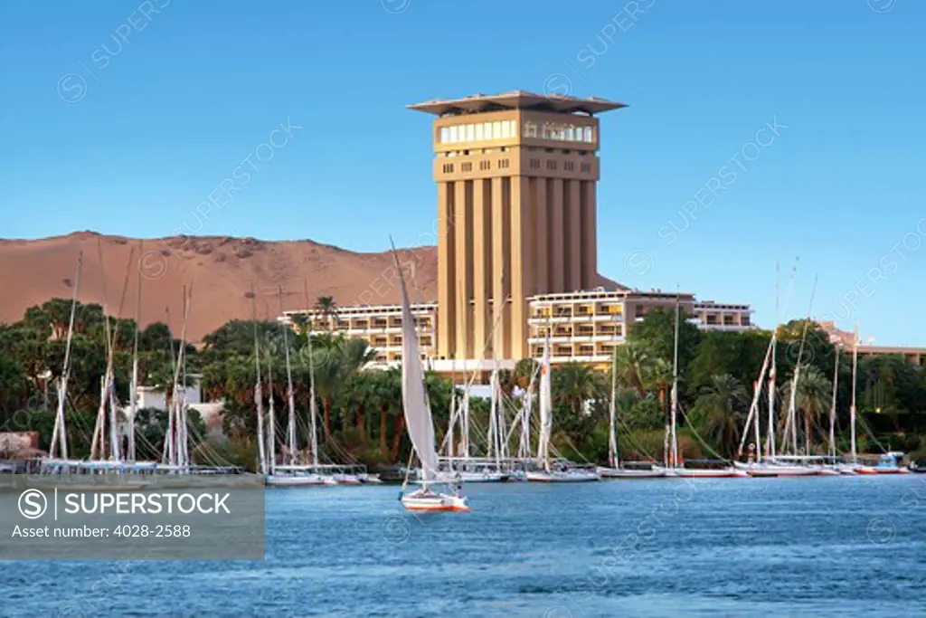 Egypt, Aswan, Elephantine Island Resort hotel on an island in the middle of the Nile River, Felucca sailboat in the river.