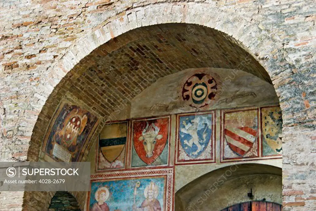 The courtyard fresco paintings of the Palazzo del Popolo near the Piazza del Duomo in San Gimignano, Tuscany.