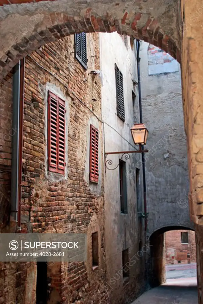 A courtyard opens up to the narrow streets and alleyways near the Piazza del Duomo in San Gimignano, Tuscany.