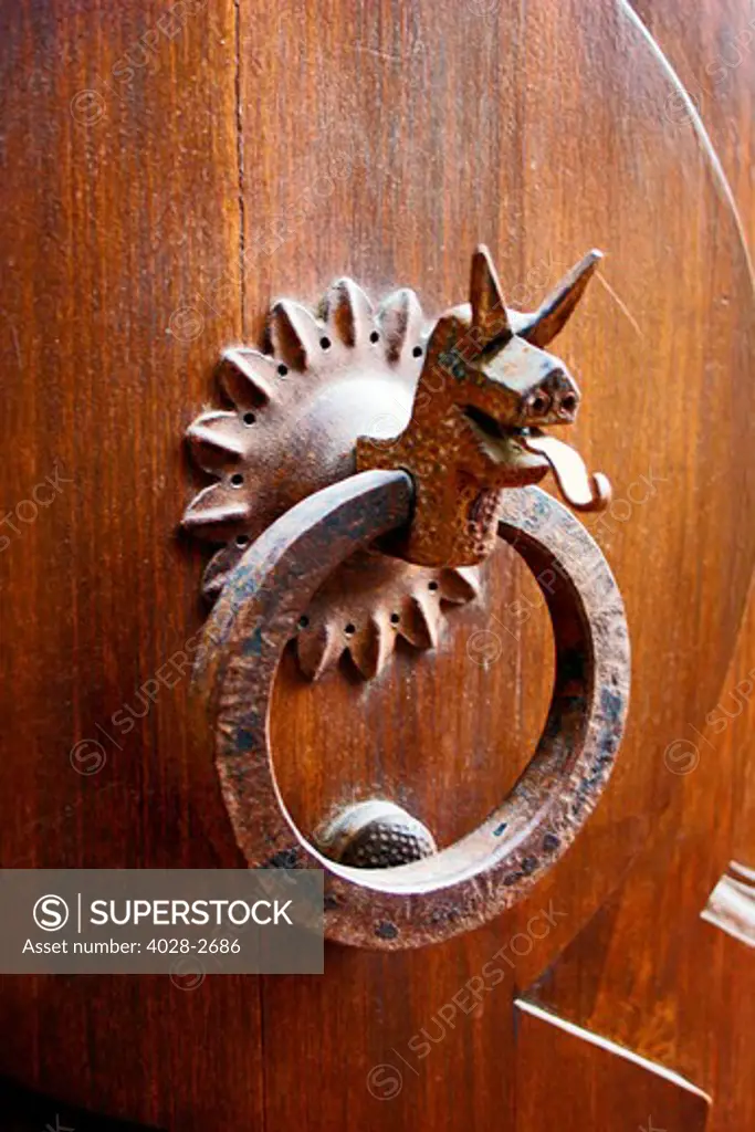 Florence, Italy, an old iron door knocker in the shape of a dragon with it's tongue sticking out