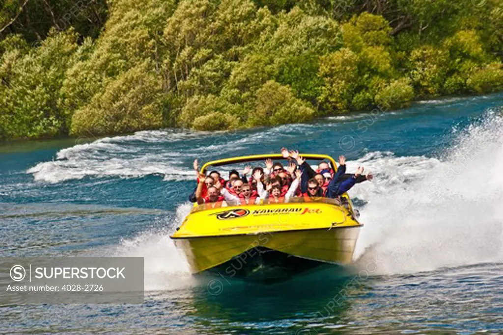 New Zealand, South Island, Clutha-Central Otago, Queenstown, thrill seekers and tourists wave on jet boat on Shotover River and Shotover Canyons