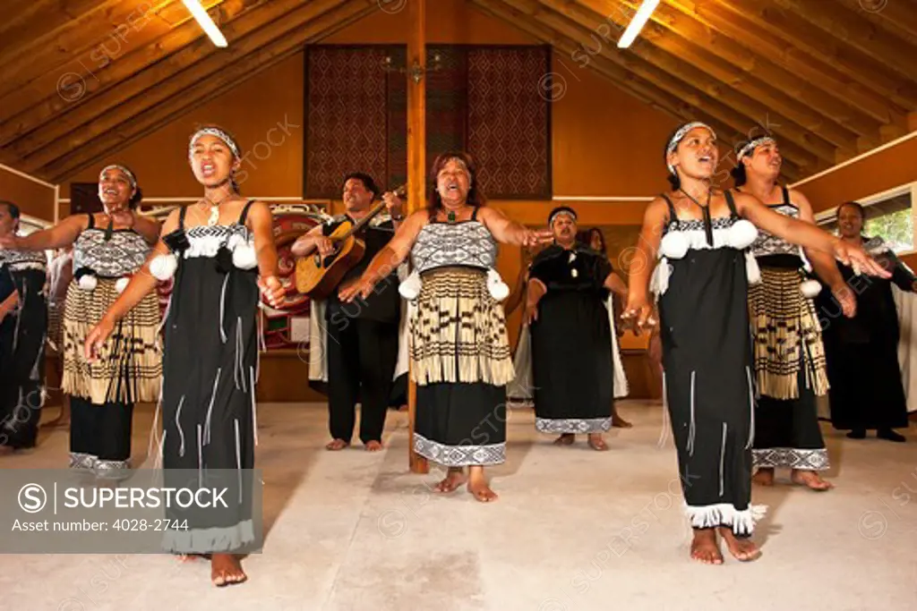Auckland, Rotorua, New Zealand, Maori women and girls perform a welcome dance and song while dressed in traditional clothing.