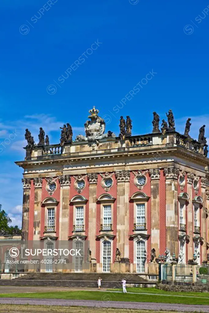 Potsdam, Brandenburg, Germany, detail of the golden royal crest and statues of the baroque New Palace (Neues Palais) in the  Sans Souci Park