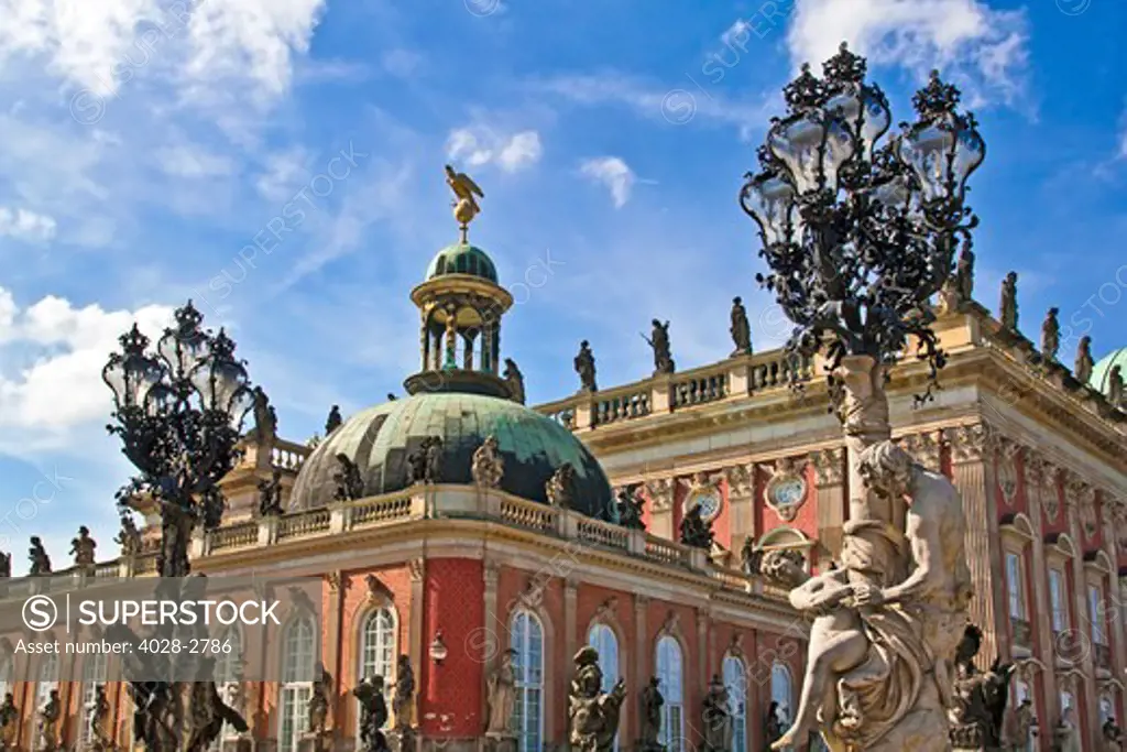 Potsdam, Brandenburg, Germany, The New Palace (Neues Palais) in the  Sans Souci Park, carriage way passes statues and ornate lamps.