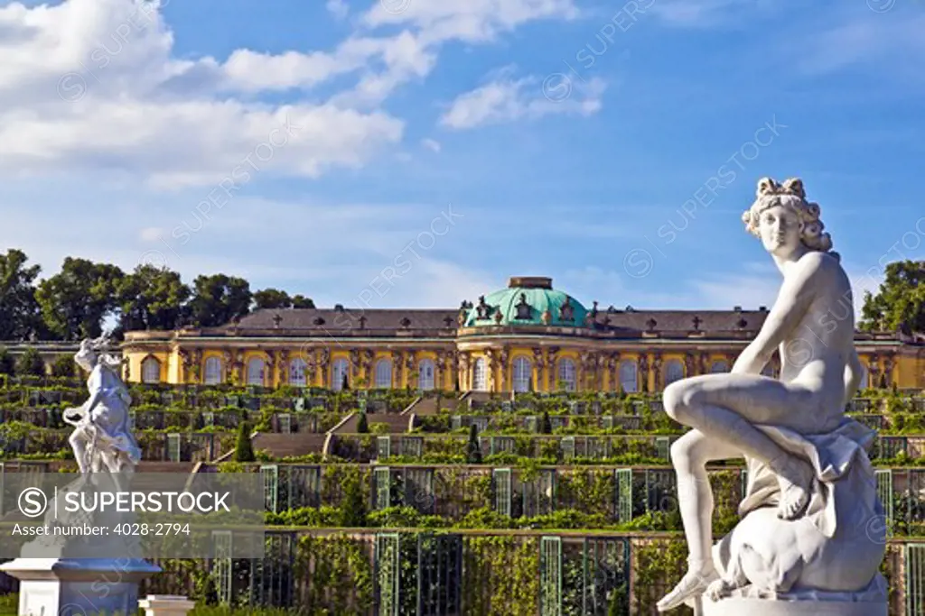 Germany, Brandenburg, Preussen, Potsdam, A statue of the Greek god Apollo and goddess Artemis next to the terraced gardens in front of main facade of Sans Souci Palace.
