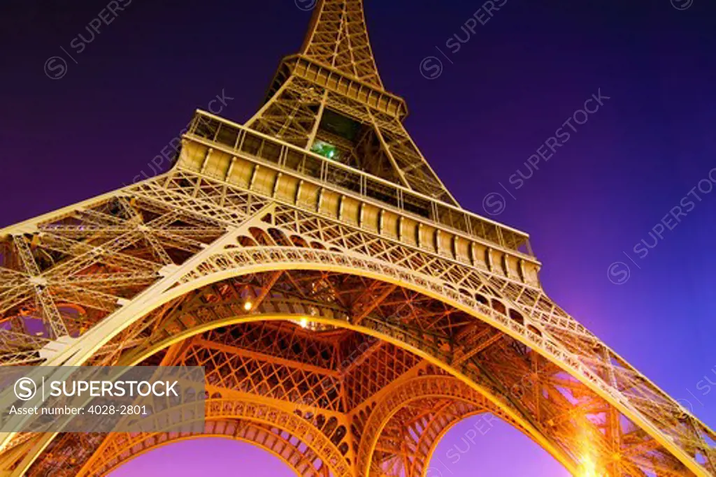 France, Paris, The Eiffel Tower (La Tour Eiffel) illuminated at night as viewed from below the structure standing 324 metres (1,063 ft) tall, 81 floors.