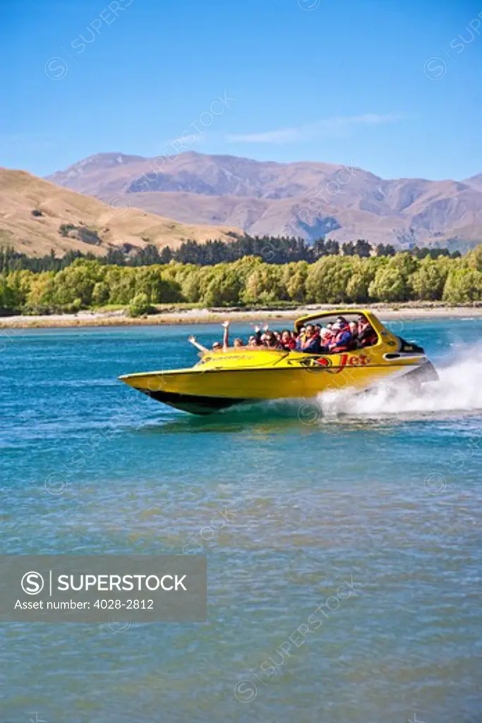 New Zealand, South Island, Clutha-Central Otago, Queenstown, thrill seekers and tourists wave on jet boat on Shotover River and Shotover Canyons