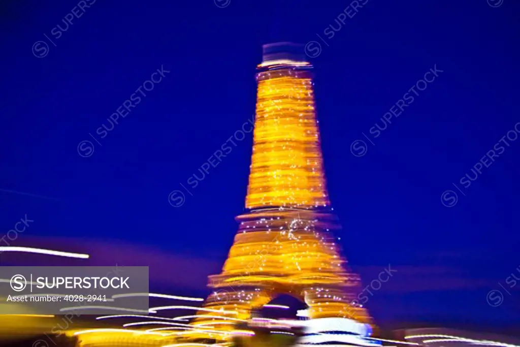 Paris, ile-de-France, France, the illuminated Eiffel Tower (Tour Eiffel) shot with motion blur at night