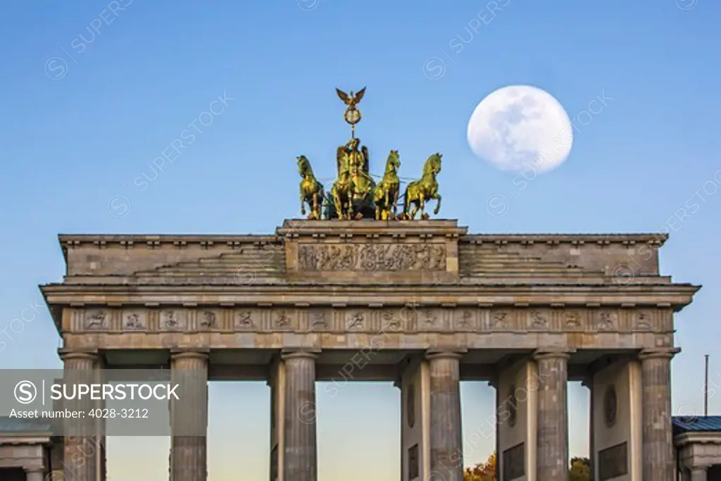 Berlin, Germany, Close-up of the Quadriga atop the Brandenburg Gate (Brandenburger Tor) with the full moon (Super Moon).