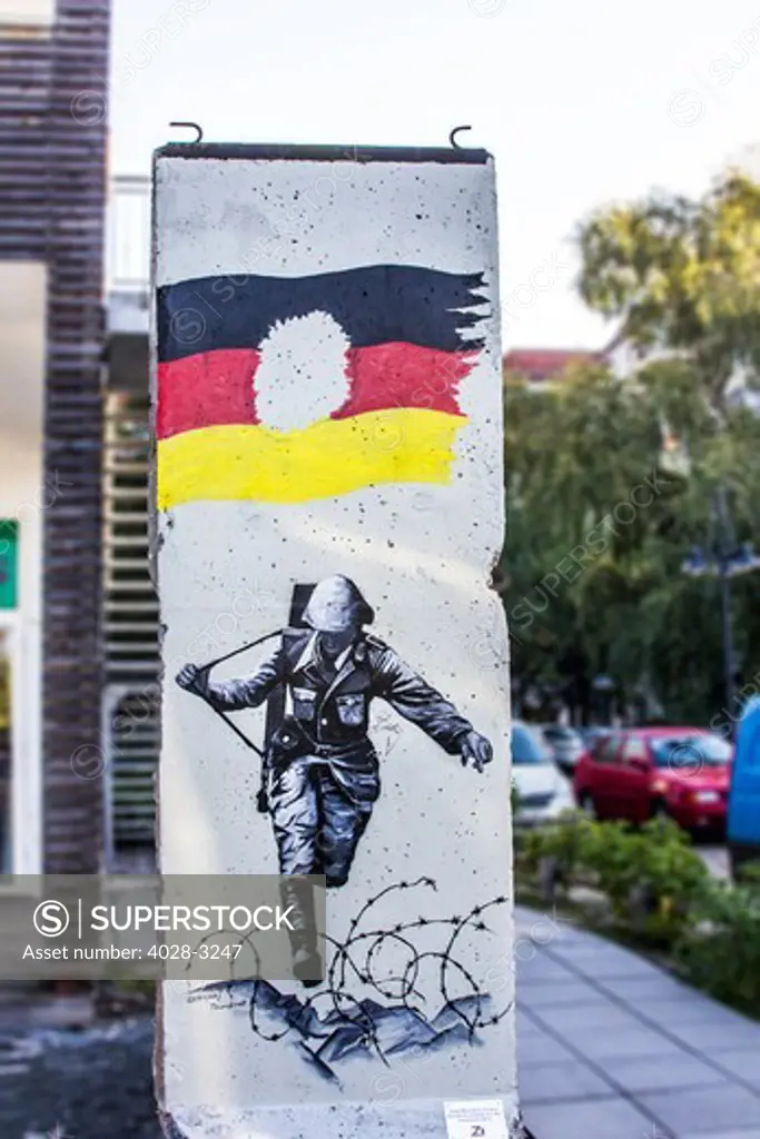 Berlin, Germany, a section of the Berlin Wall on display near Adolph Hitler's Bunker displaying an image of a German soldier during World War II