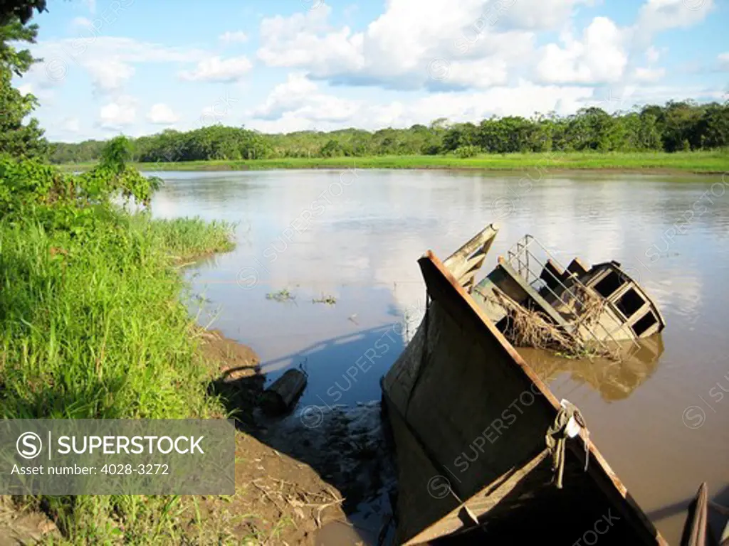 An old wrecked River Boat sunk in the Amazon River and jungle in Peru or Brazil