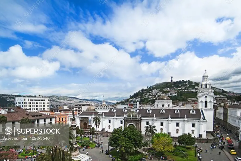 Plaza de la Independencia with the Cathedral and the Palacio de Gobierno. Quito, Ecuador with the Statue of Virgin of Quito standing above the city on El Panecillo hill.
