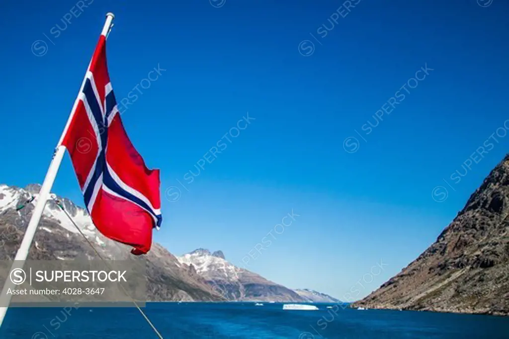 Greenland, Prinz Christian Sund fjord, Kujalleq, Norwegian flag waves off the stern of a cruise ship