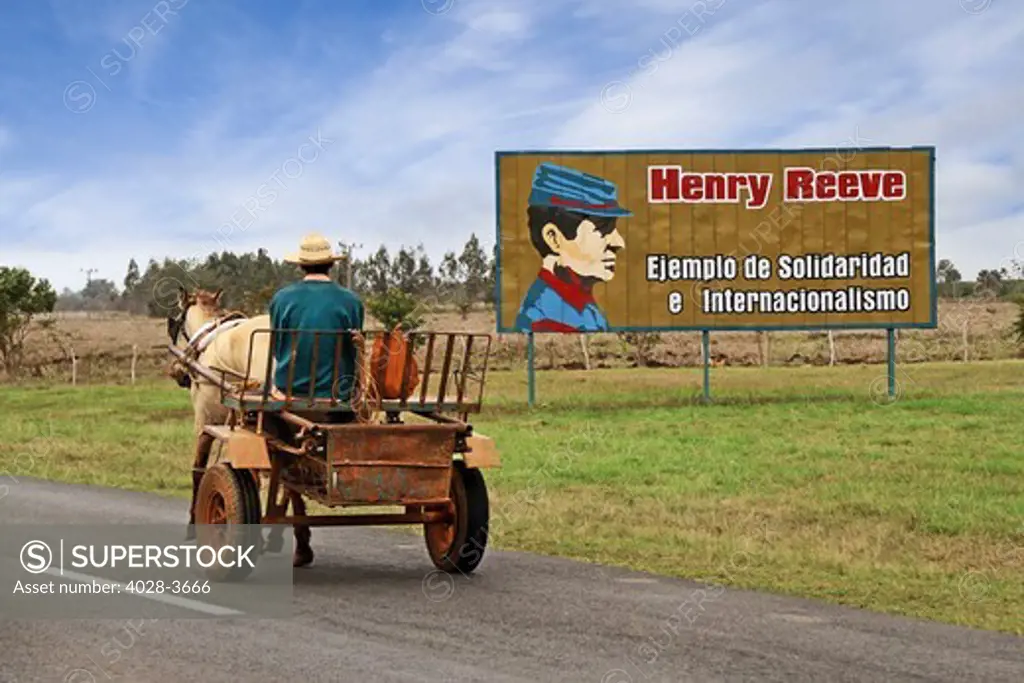 Cuba, Santa Clara, a horse and small wagon painted billboard commerating Henry Reeve as an example of solidarity and internationalism