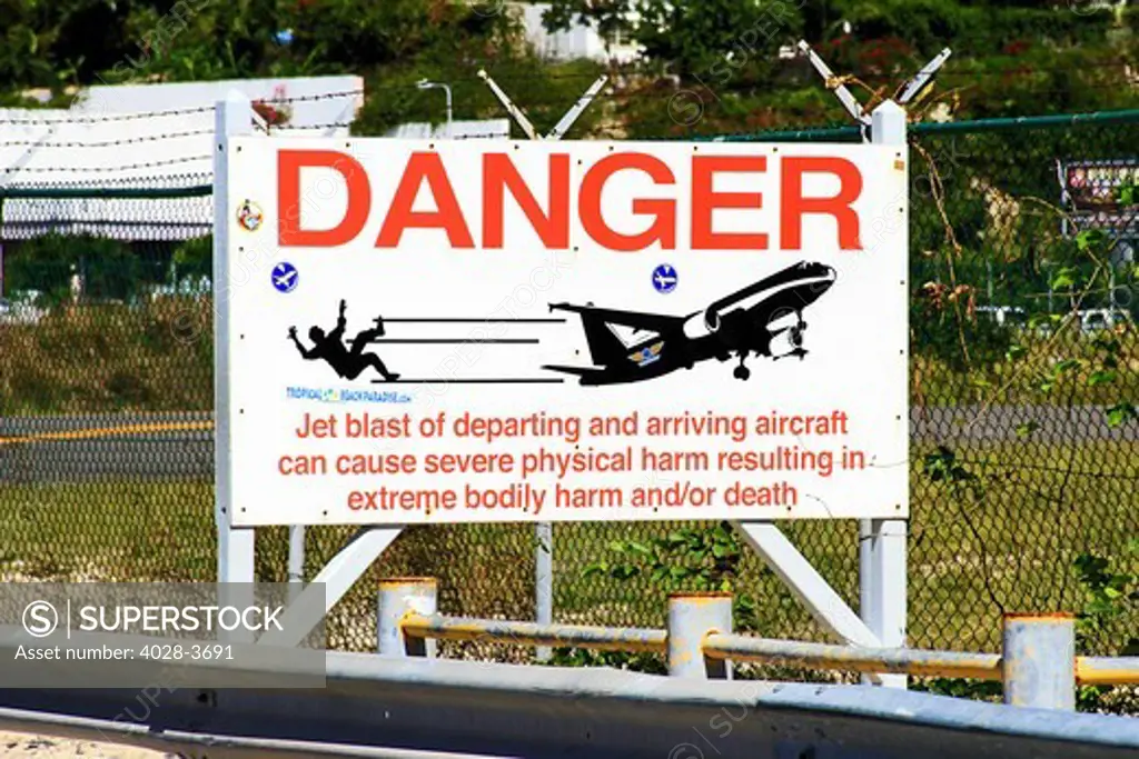 St Martin, Netherland Antilles, Maho Beach, warning sign for beach goers about airplance landing over the beach in St. Maarten