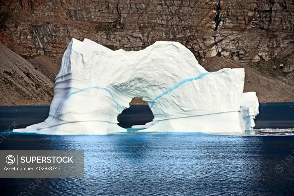 Greenland, Disko Bay, floating iceberg with a natural arch from the Ilulissat Kangerlua Glacier also known as Sermeq Kujalleq