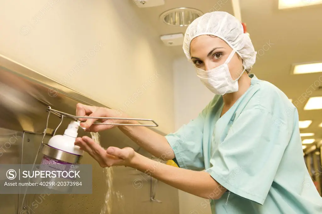 Surgeon washing her hands 