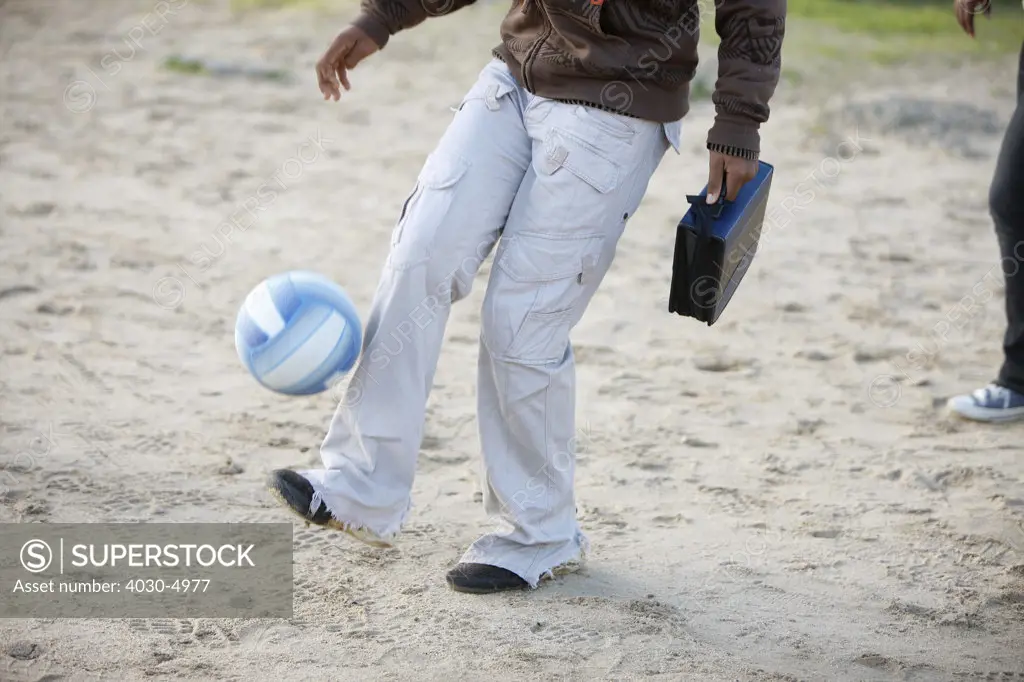 Boy kicking soccer ball, Cape Town, South Africa