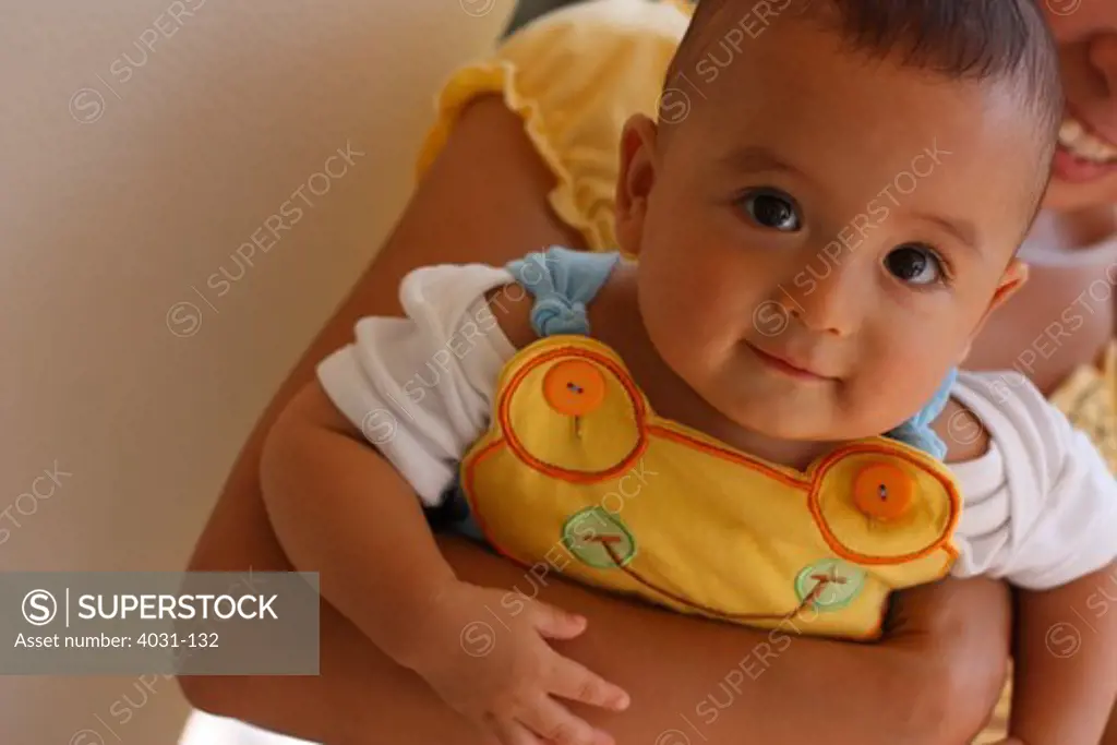 Half Asian and half Caucasian baby being held