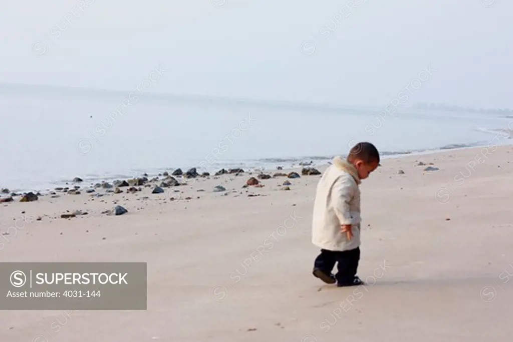 Boy walking on the beach, Kinmen County, Taiwan