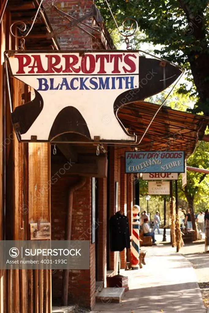 Signboards hanging outside stores, Columbia State Historic Park, Columbia, Tuolumne County, California, USA