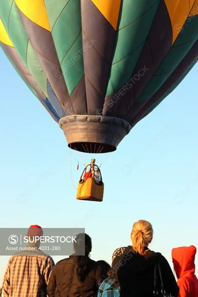 USA, California, Ripon, Spectators watching hot air balloon take off at Color the Skies Hot Air Balloon Festival