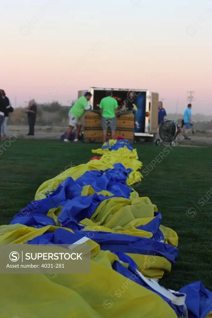 USA, California, Ripon, Crew members assembling hot air balloon at Color the Skies Hot Air Balloon Festival