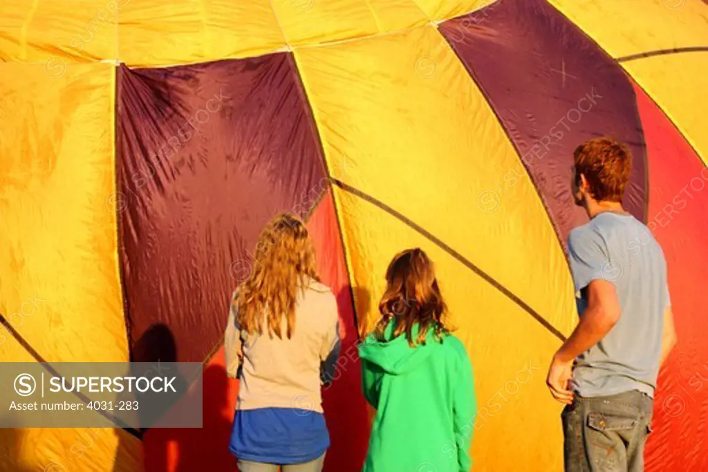 USA, California, Ripon, Crew members by inflating hot air balloon at Color the Skies Hot Air Balloon Festival