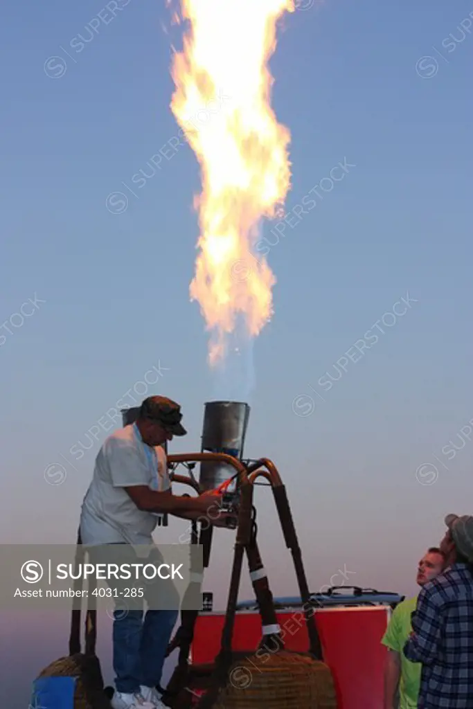 USA, California, Ripon, Crew members testing hot air balloon burners at Color the Skies Hot Air Balloon Festival
