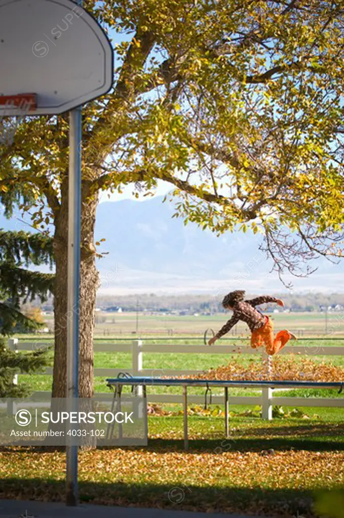 Teenage girl jumping on a trampoline, Bozeman, Gallatin County, Montana, USA