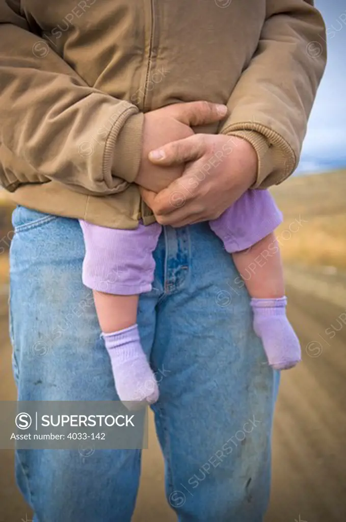 Young man carrying his daughter in his coat, Bozeman, Gallatin County, Montana, USA