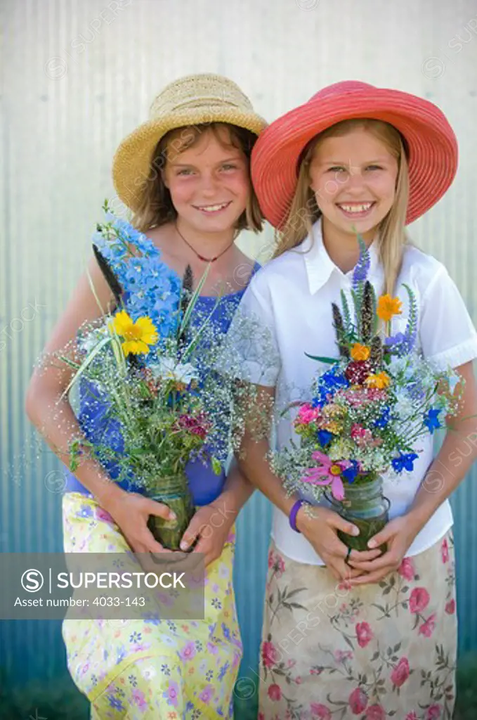 Two girls holding vases and smiling, Bozeman, Gallatin County, Montana, USA