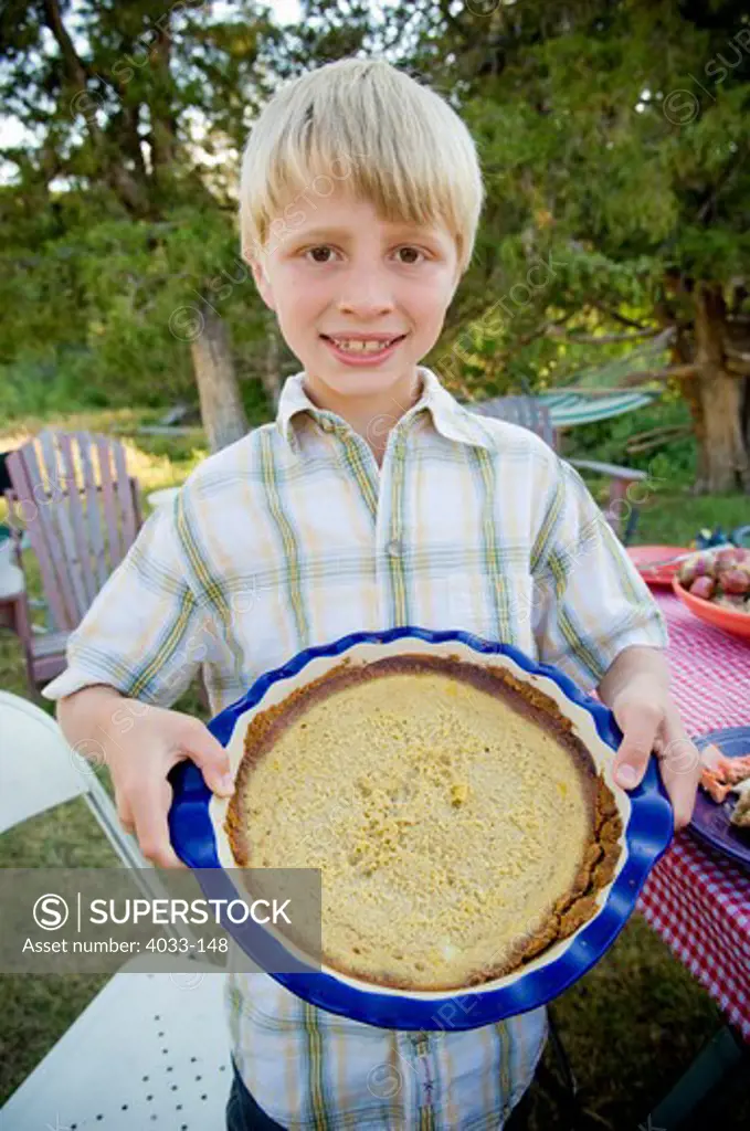 Boy with homemade pie, Bozeman, Gallatin County, Montana, USA