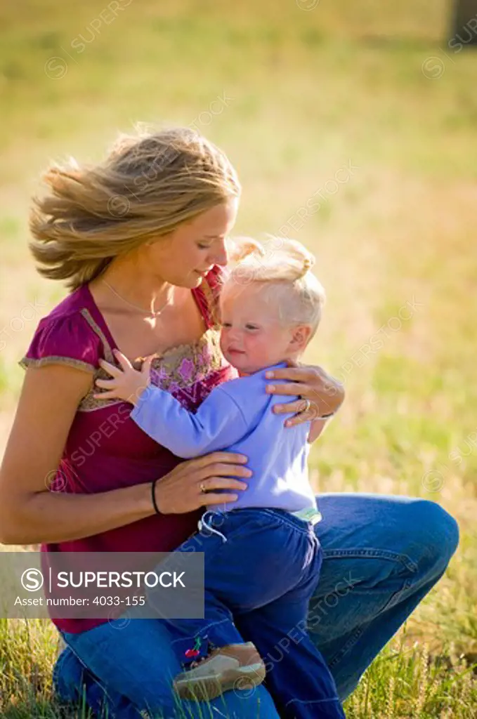 Pregnant young woman hugging her daughter, Bozeman, Gallatin County, Montana, USA