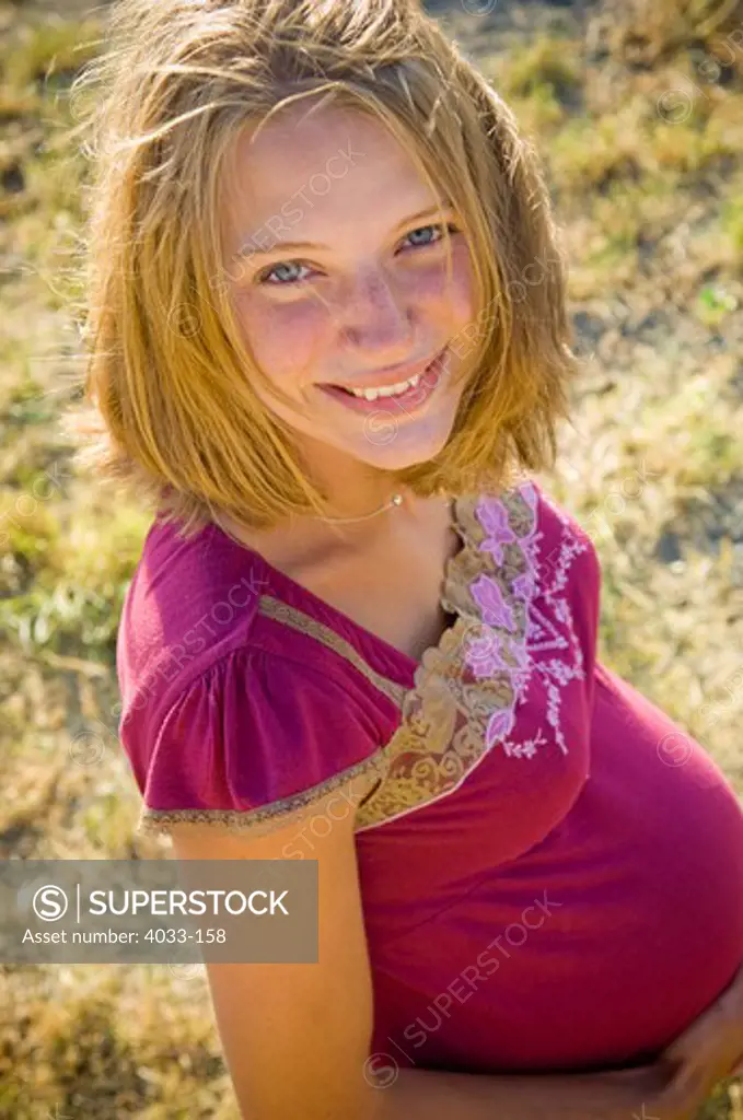 Portrait of a pregnant young woman smiling, Bozeman, Gallatin County, Montana, USA