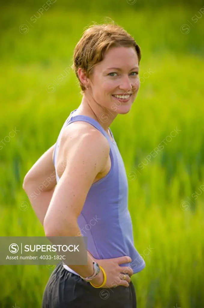 Woman exercising in a wheat field, Bozeman, Gallatin County, Montana, USA