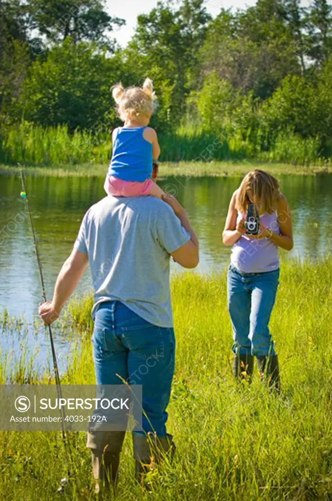 Young woman taking picture of her family with a camera, Bozeman, Gallatin County, Montana, USA