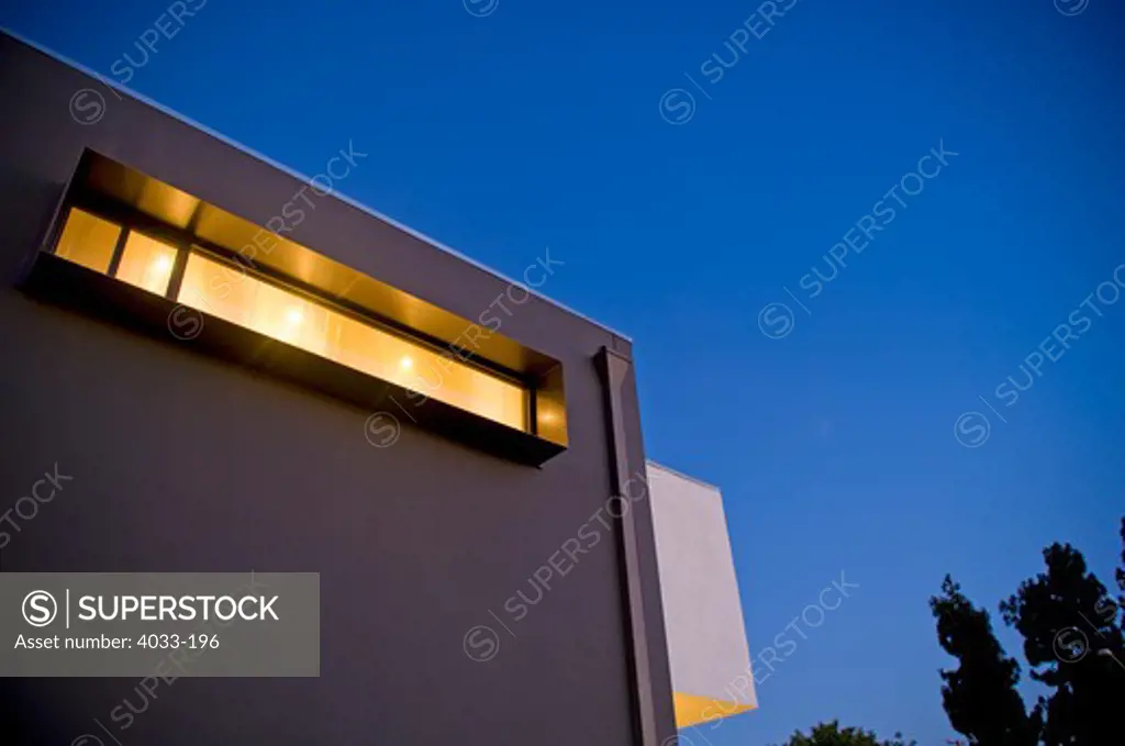 Low angle view of an office building lit up at night, San Diego, California, USA