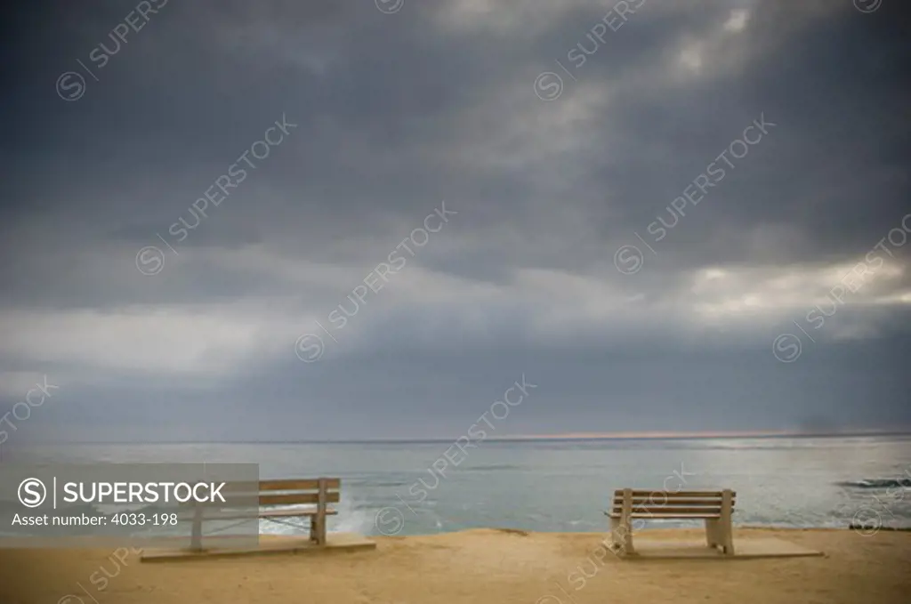 Seascape with storm clouds and empty benches, La Jolla, San Diego County, California, USA