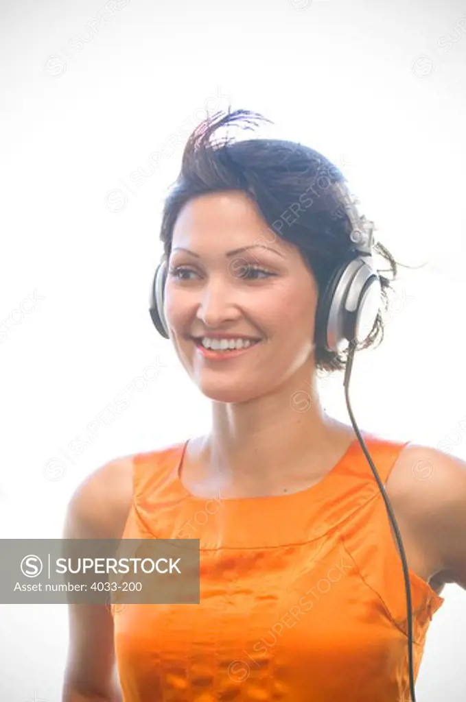 Close-up of a young woman listening to headphones, California, USA