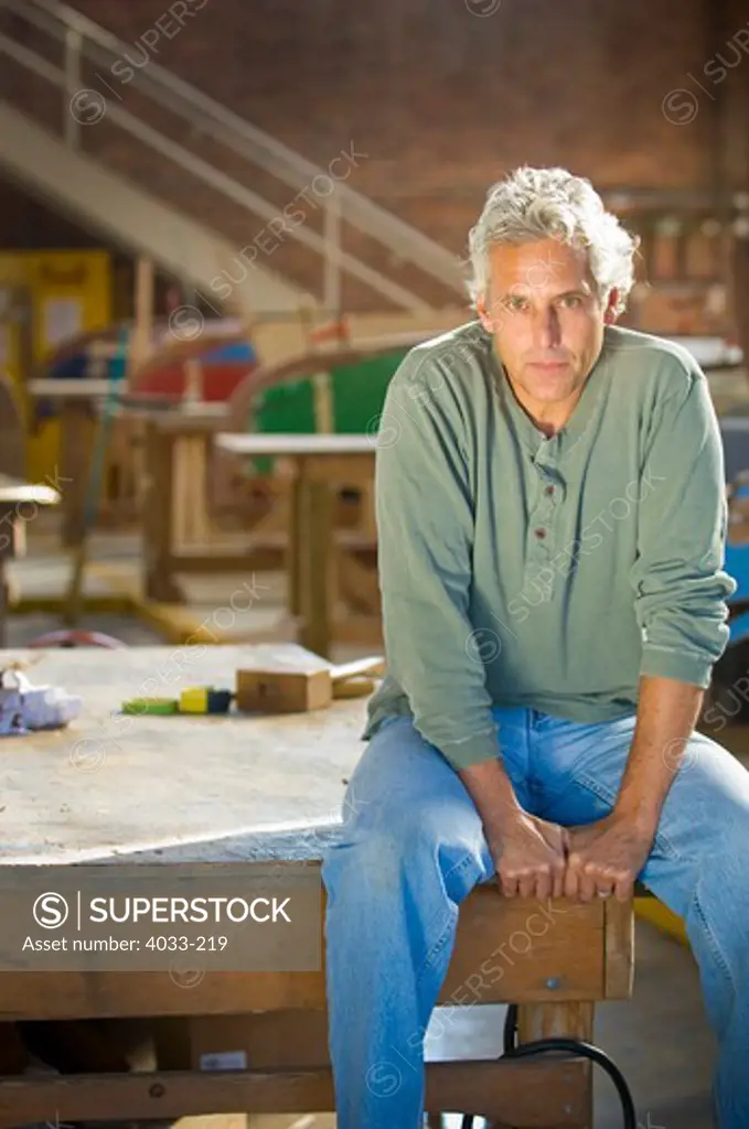 Mid adult man in a sailboat restoration building, Newport, Rhode Island, USA