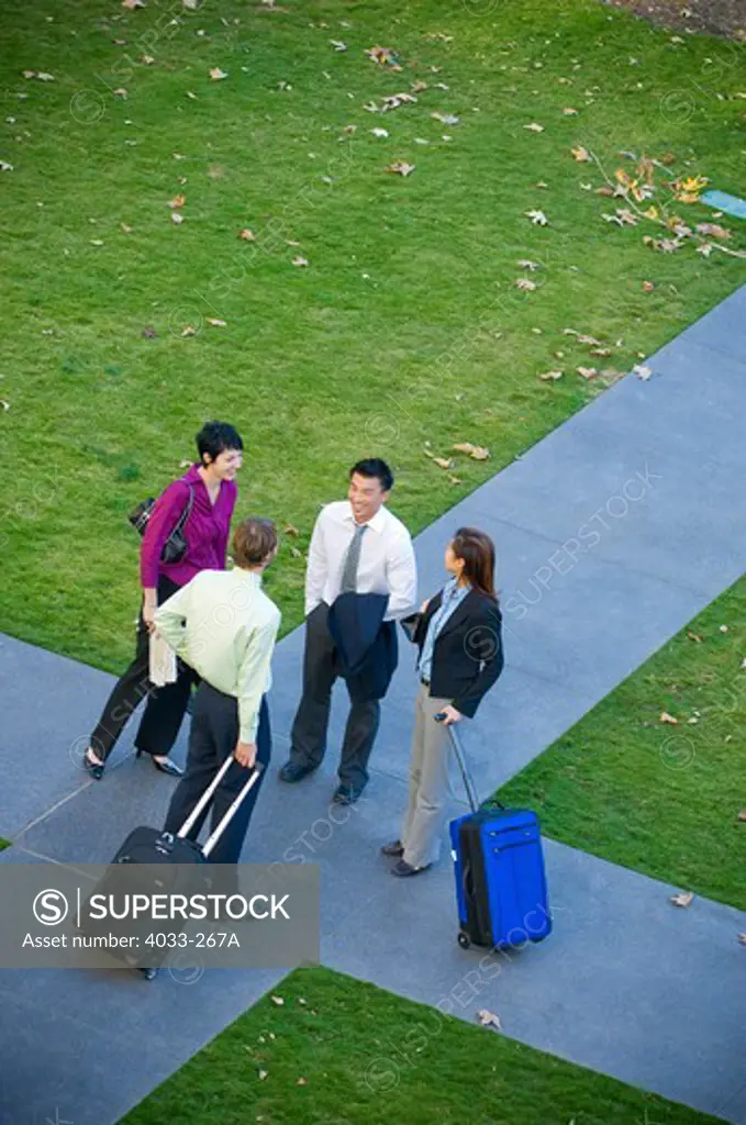 High angle view of business executives discussing at a crossroad, La Jolla, San Diego County, California, USA