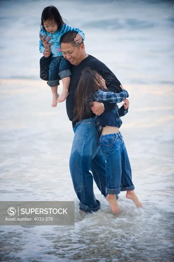 Mid adult man enjoying with his daughters on the beach, La Jolla, California, USA