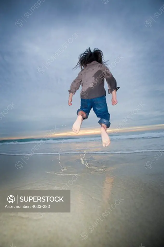 Boy jumping on the beach, La Jolla, California, USA