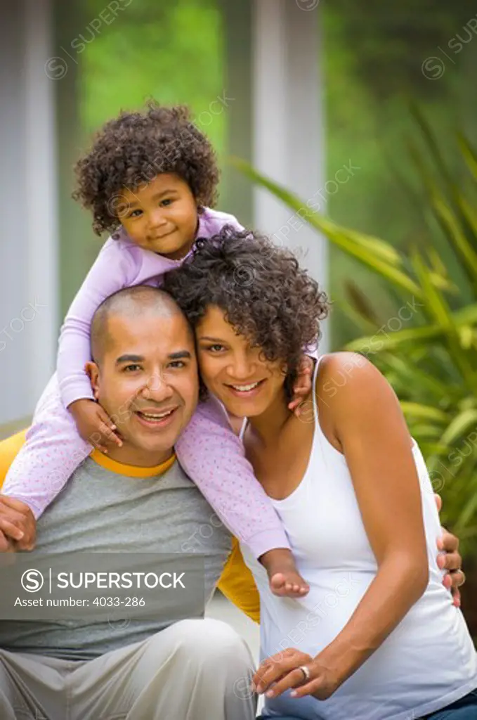 Young couple smiling with their daughter, San Diego, California, USA