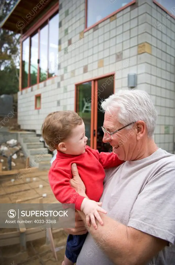 Senior man holding his grandson, San Diego, California, USA